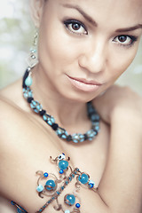 Image showing Woman with blue jewelry
