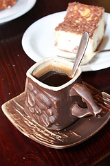 Image showing cup of coffee and portion of cake