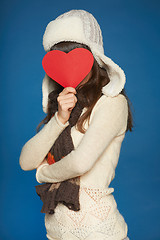 Image showing Winter girl holding heart shape in front of face