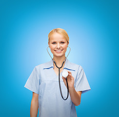 Image showing smiling female doctor or nurse with stethoscope