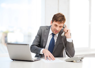 Image showing businessman with laptop computer and phone