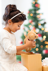 Image showing happy child girl with gift box and teddy bear