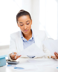 Image showing businesswoman working with calculator in office