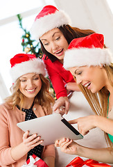 Image showing three women in santa helper hats with tablet pc