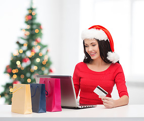 Image showing woman with shopping bags, laptop and credit card