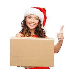 Image showing smiling woman in santa helper hat with parcel box