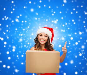 Image showing smiling woman in santa helper hat with parcel box