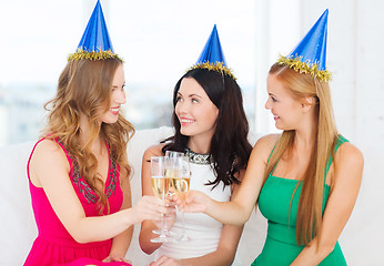 Image showing three women wearing hats with champagne glasses