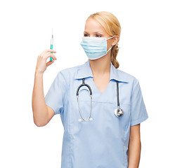 Image showing female doctor or nurse in mask holding syringe