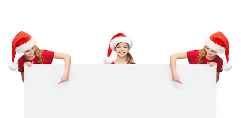 Image showing girls in santa helper hats with blank white board