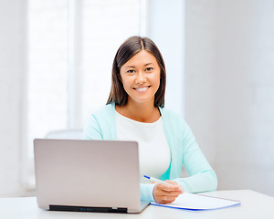 Image showing asian businesswoman with laptop and documents