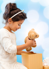 Image showing happy child girl with gift box and teddy bear