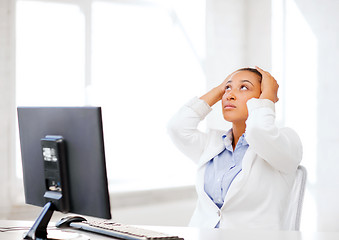 Image showing stressed african woman with computer