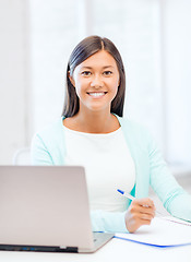 Image showing asian businesswoman with laptop and documents