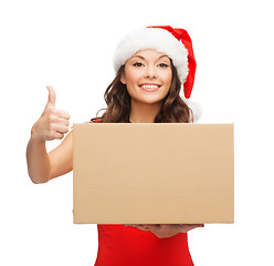 Image showing smiling woman in santa helper hat with parcel box