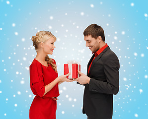 Image showing smiling woman and man with gift box