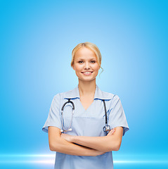Image showing female doctor or nurse in mask holding syringe