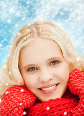 Image showing smiling teenage girl in red mittens and scarf