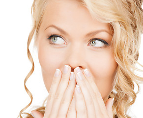 Image showing face of beautiful woman covering her mouth