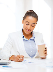 Image showing businesswoman with documents and takeaway coffee