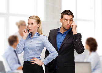 Image showing woman and man with cell phones calling