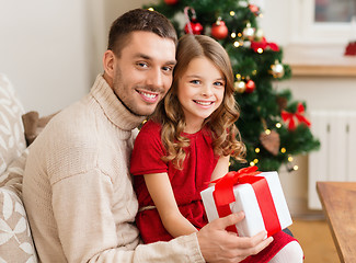 Image showing smiling father and daughter holding gift box