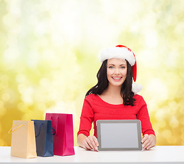 Image showing smiling woman in santa helper hat with tablet pc