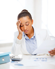 Image showing businesswoman working with calculator in office