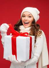 Image showing smiling woman in white clothes with gift box