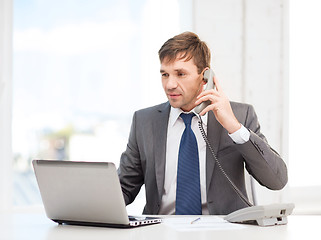 Image showing businessman with laptop computer and phone