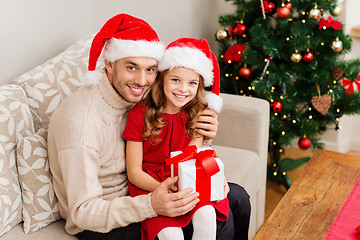 Image showing smiling father and daughter holding gift box