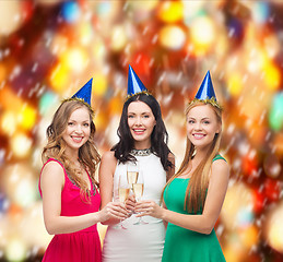 Image showing three women wearing hats with champagne glasses