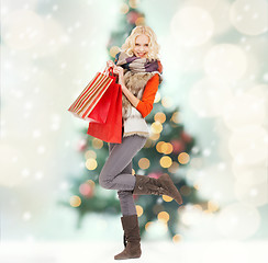 Image showing teenage girl in winter clothes with shopping bags