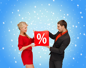 Image showing smiling woman and man with red percent sale sign