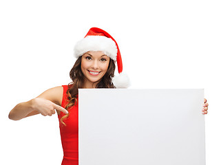 Image showing woman in santa helper hat with blank white board