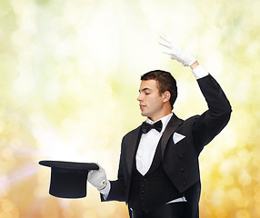 Image showing magician in top hat showing trick