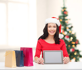 Image showing smiling woman in santa helper hat with tablet pc