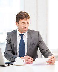 Image showing businessman with laptop computer and documents