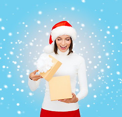 Image showing surprised woman in santa helper hat with gift box