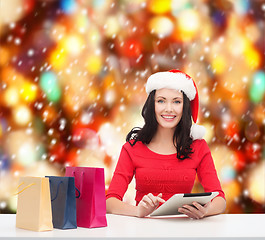 Image showing smiling woman with shopping bags and tablet pc