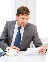 Image showing businessman with laptop computer and documents