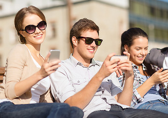 Image showing students looking at smartphones and tablet pc