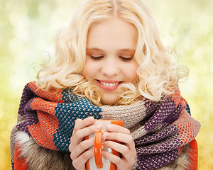 Image showing smiling teenage girl with tea or coffee mug
