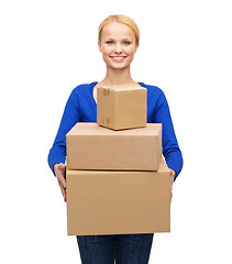 Image showing smiling woman in casual clothes with parcel boxes