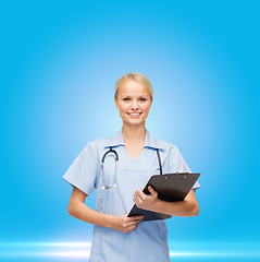 Image showing female doctor or nurse in mask holding syringe