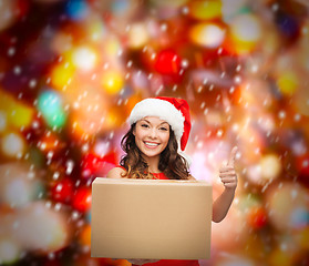 Image showing smiling woman in santa helper hat with parcel box