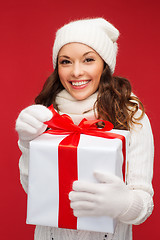 Image showing smiling woman in white clothes with gift box