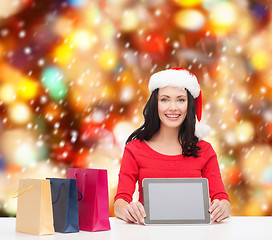 Image showing smiling woman in santa helper hat with tablet pc