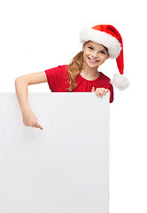 Image showing child in santa helper hat with blank white board