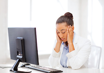 Image showing stressed african woman with computer